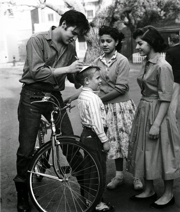Elvis Presley signs autographs for fans in Germany, ca. 1959